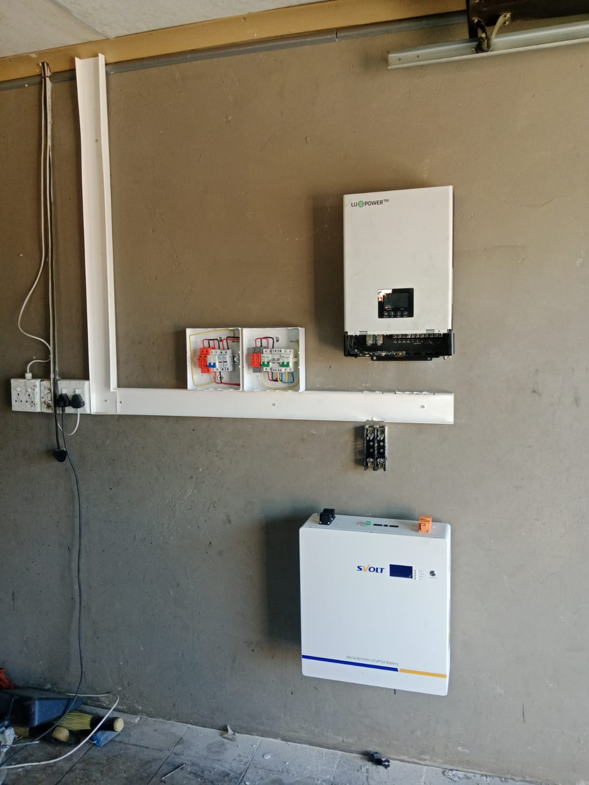 Completed inverter and battery system on a residential wall