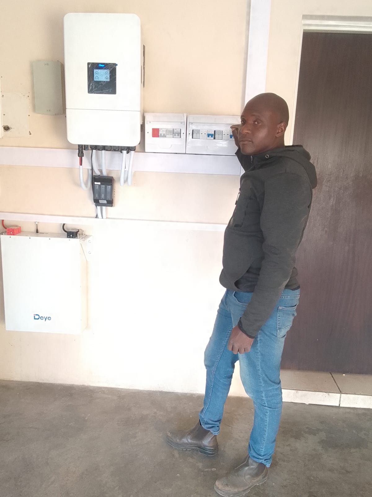 Technician inspecting a residential inverter installation