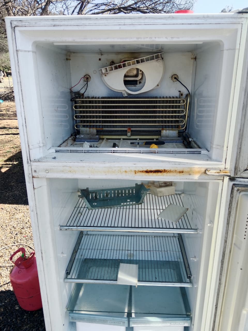 Open appliance unit showing repair and maintenance work