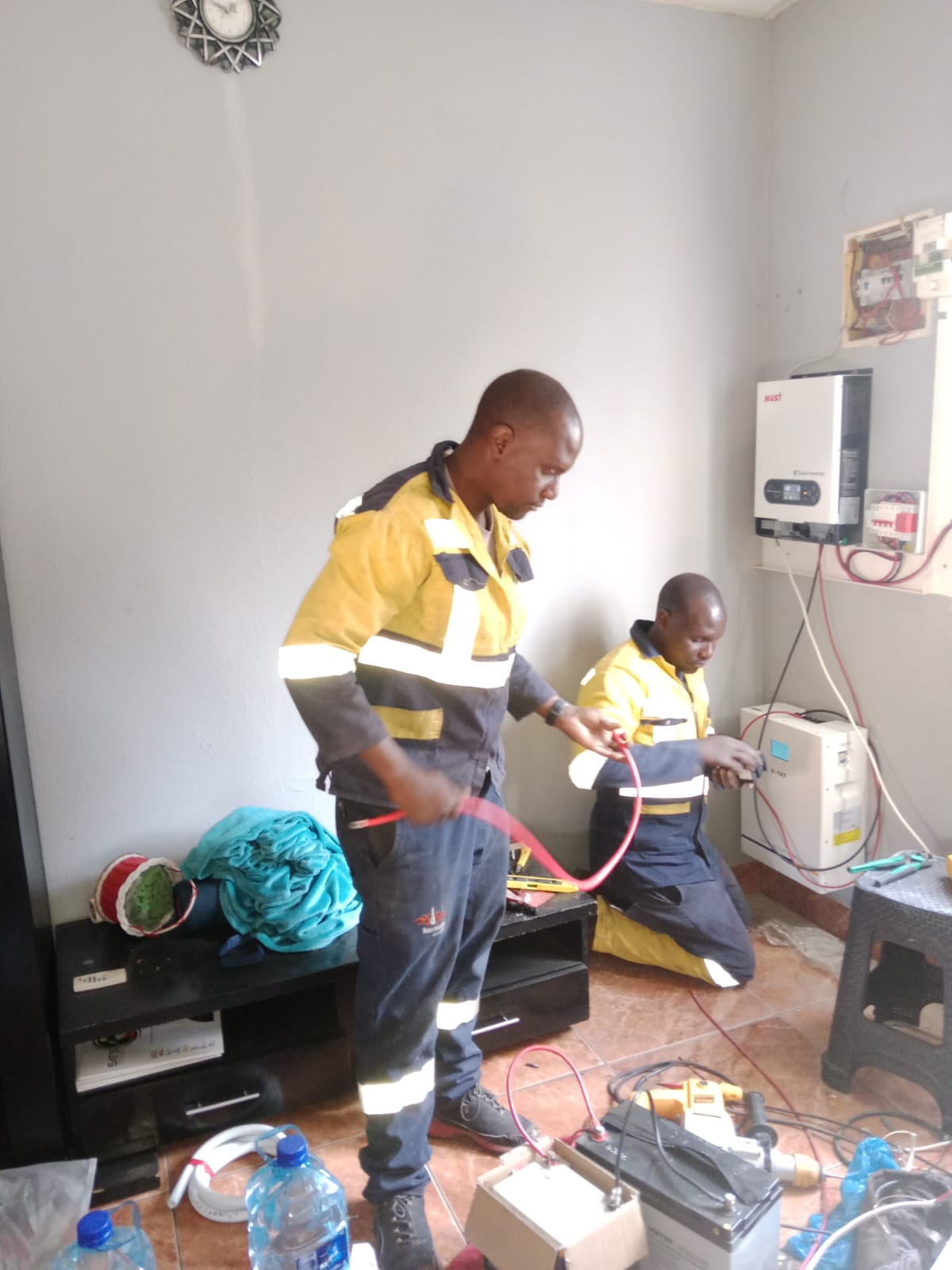 Technician troubleshooting an inverter or electrical system